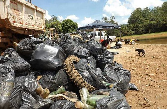 Voluntários retiram até lixo hospitalar da represa de Peti